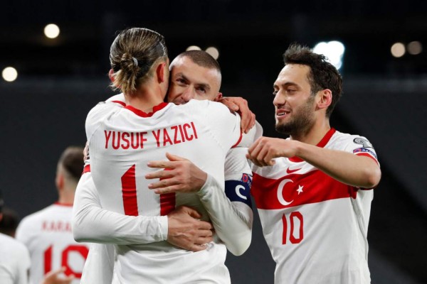 Turkey's forward Burak Yilmaz (C) celebrates with teammates after scoring his second goal during the FIFA World Cup Qatar 2022 qualification Group G football match between Turkey and The Netherlands at the Ataturk Olympic Stadium, in Istanbul, on March 24, 2021. (Photo by MURAD SEZER / POOL / AFP)