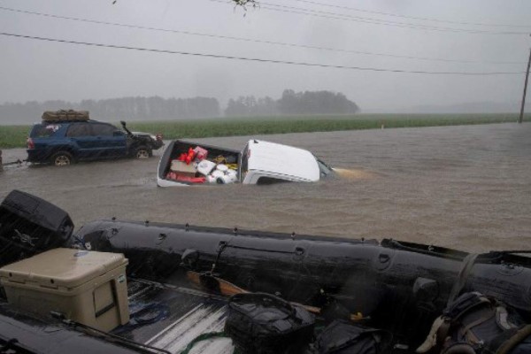 A pickup truck is seen submerged in floodwater in Lumberton, North Carolina, on September 15, 2018 in the wake of Hurricane Florence. Besides federal and state emergency crews, rescuers were being helped by volunteers from the 'Cajun Navy' -- civilians equipped with light boats, canoes and air mattresses -- who also turned up in Houston during Hurricane Harvey to carry out water rescues. / AFP PHOTO / Alex Edelman