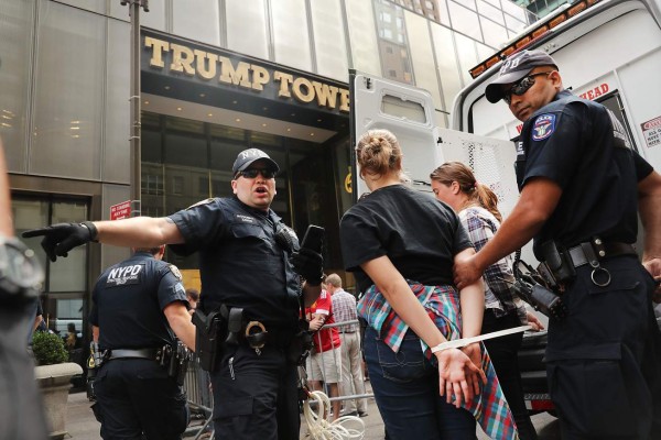 NEW YORK, NY - AUGUST 31: Protesters who had blocked the entrance to Trump Tower in Manhattan are arrested on August 31, 2016 in New York City. The action, called hecho por inmigrantes, or built by immigrants, was intended to draw attention to Republican presidential nominee Donald Trump's immigration policies on the day he is set to give a major speech on immigration in Arizona. The protersters stressed that immigrants were involed in the building of Twump Tower. Trump has previously vowed to deport undocumented immigrants if elected. Spencer Platt/Getty Images/AFP