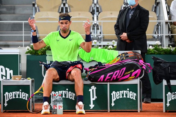 Spain's Rafael Nadal reacts during a break during his men's singles semi-final tennis match against Serbia's Novak Djokovic on Day 13 of The Roland Garros 2021 French Open tennis tournament in Paris on June 11, 2021. (Photo by MARTIN BUREAU / AFP)