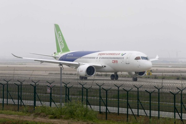 (FILES) This file photo taken on April 16, 2017 shows China's first big passenger plane, the C919, being given the first high-speed taxi test at Shanghai Pudong International Airport in Shanghai. China is expected within days to carry out the maiden test flight of a home-grown passenger jet built to meet soaring Chinese travel demand and challenge the dominance of Boeing and Airbus. The C919, built by state-owned aerospace manufacturer Commercial Aircraft Corporation of China (COMAC), was set to take wing over Shanghai and could be cleared for takeoff as early as May 5, 2017, according to state media. / AFP PHOTO / STR / China OUT / TO GO WITH China-aviation-manufacturing, ADVANCER by Albee ZHANG