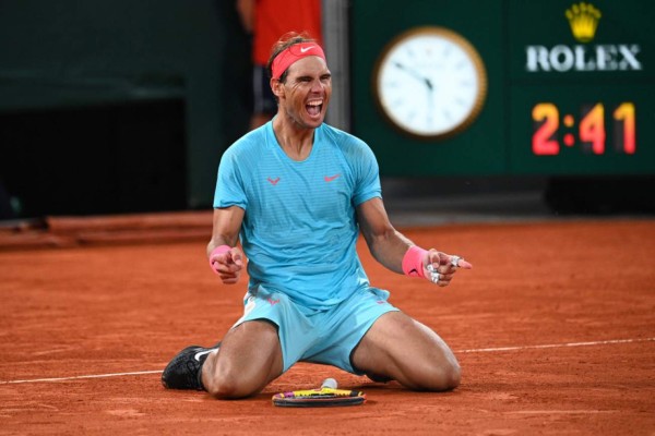 Spain's Rafael Nadal celebrates after winning against Serbia's Novak Djokovic at the end of their men's final tennis match at the Philippe Chatrier court on Day 15 of The Roland Garros 2020 French Open tennis tournament in Paris on October 11, 2020. (Photo by Anne-Christine POUJOULAT / AFP)
