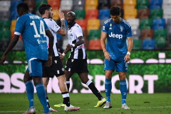 Juventus' Portuguese forward Cristiano Ronaldo (R) reacts during Italian Serie A football match between Udinese and Juventus on July 23, 2020, at the Dacia Arena Stadium in Udine. (Photo by MARCO BERTORELLO / AFP)