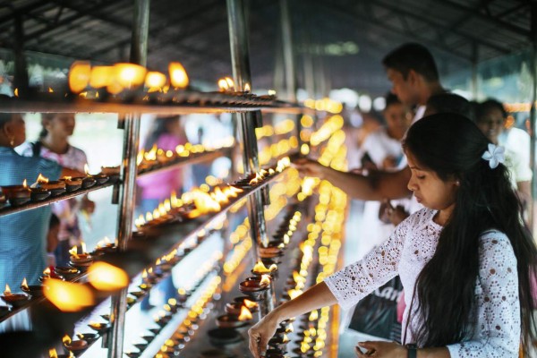 Kandy, Sri Lanka - April 3, 2015: People are burning oil lamps as religious ritual in the Temple of the tooth.