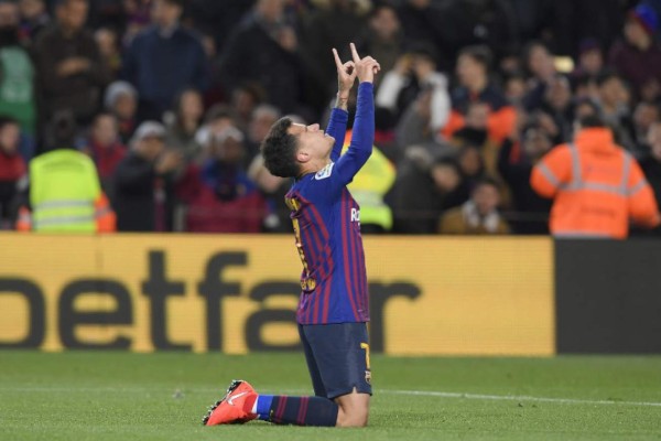 Barcelona's Brazilian midfielder Philippe Coutinho celebrates after scoring during the Spanish Copa del Rey (King's Cup) quarter-final second leg football match between Barcelona and Sevilla at the Camp Nou stadium in Barcelona on January 30, 2019. (Photo by LLUIS GENE / AFP)