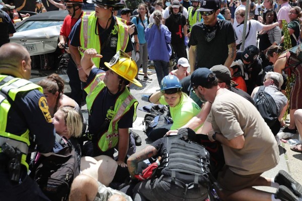 CHARLOTTESVILLE, VA - AUGUST 12: Rescue workers and medics tend to many people who were injured when a car plowed through a crowd of anti-facist counter-demonstrators marching through the downtown shopping district August 12, 2017 in Charlottesville, Virginia. The car plowed through the crowed following the shutdown of the 'Unite the Right' rally by police after white nationalists, neo-Nazis and members of the 'alt-right' and counter-protesters clashed near Emancipation Park, where a statue of Confederate General Robert E. Lee is slated to be removed. Chip Somodevilla/Getty Images/AFP