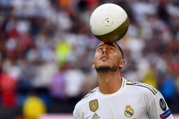 Belgian footballer Eden Hazard plays with a ball during his official presentation as new player of the Real Madrid CF at the Santiago Bernabeu stadium in Madrid on June 13, 2019. (Photo by GABRIEL BOUYS / AFP)