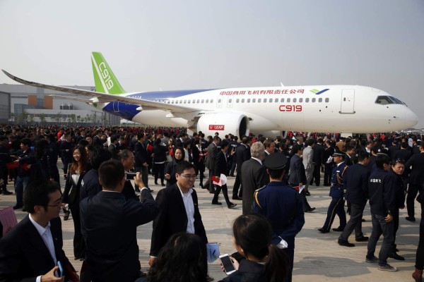 (FILES) This file photo taken on November 2, 2015 shows China's first big passenger plane, the C919, on display at a facility in commercial hub in Shanghai. China is expected within days to carry out the maiden test flight of a home-grown passenger jet built to meet soaring Chinese travel demand and challenge the dominance of Boeing and Airbus. The C919, built by state-owned aerospace manufacturer Commercial Aircraft Corporation of China (COMAC), was set to take wing over Shanghai and could be cleared for takeoff as early as May 5, 2017, according to state media. / AFP PHOTO / STR / China OUT / TO GO WITH China-aviation-manufacturing, ADVANCER by Albee ZHANG
