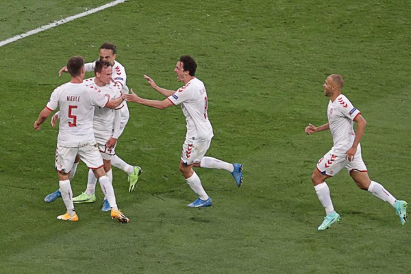 Denmark's forward Mikkel Damsgaard (2nd-L) celebrates after scoring his team's first goal during the UEFA EURO 2020 Group B football match between Russia and Denmark at Parken Stadium in Copenhagen on June 21, 2021. (Photo by HANNAH MCKAY / POOL / AFP)