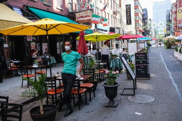 NEW YORK, NY - JULY 04: People dine al fresco in Little Italy on Mulberry Street between Hester and Broome Streets on July 4, 2020 in the Manhattan borough of New York City. Mayor Bill de Blasio has expanded and combined the popular programs, Open Streets and Open Restaurants, as the city opens up streets to outdoor dining as COVID-19 cases ease. Byron Smith/Getty Images/AFP== FOR NEWSPAPERS, INTERNET, TELCOS & TELEVISION USE ONLY ==