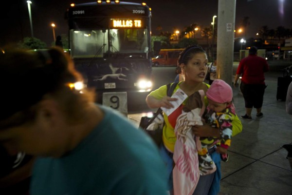 MCALLEN, TX-JUNE 12, 2014: Larisa Lara holds her 6-month-old daughter Annie, as she boards a bus at the McAllen bus terminal. Lara, from Honduras, spent 10 days crossing Mexico with her daughter, and is planning on going to Dallas to join her father. A surge in immigrants entering the United States from Central America has immigration officials scrambling on where to place them. Detention centers are overflowing and rumors have spread throughout Latin America that families accompanied by children can get into the country without being deported. (Photo by Michael Robinson Chavez/Los Angeles Times via Getty Images)