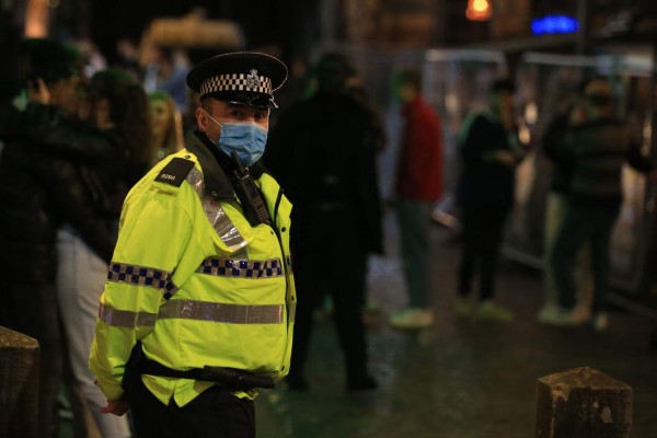 Police patrol as revellers enjoy a night out in the centre of Liverpool, north west England on October 10, 2020 ahead of new measures set to be introduced in the northwest next week to help stem the spread of the novel coronavirus. - Prime Minister Boris Johnson is expected to outline the new regime on Monday as rates of Covid 19 infection surge particularly in the north, worsening a national death toll of more than 42,000 which is already the worst in Europe. (Photo by Lindsey Parnaby / AFP)