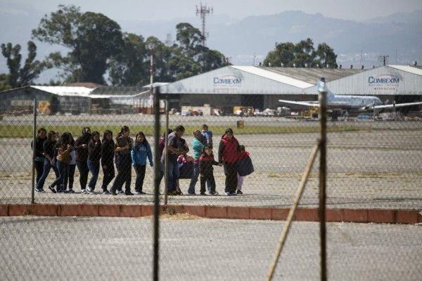 Guatemalan migrants deported from the United States arrive at the processing center at an Air Force base in Guatemala City, Guatemala, on Monday, Dec. 28, 2015. Undocumented Guatemalans detained in the U.S. are deported via airplane and land at this base where they are registered, photographed and fingerprinted before traveling to other destinations. Photographer: Nadia Sussman/Bloomberg via Getty Images