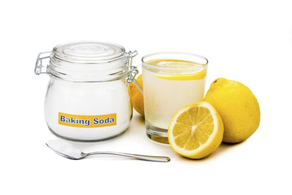 Baking soda with lemon juice in glass for multiple holistic usages