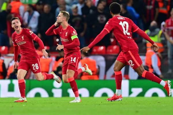 Liverpool's English midfielder Jordan Henderson (C) celebrates with teammates after scoring his team's third goal during the UEFA Champions League 1st round Group B football match between Liverpool and AC Milan at Anfield in Liverpool, north west England on September 15, 2021. (Photo by Paul ELLIS / AFP)