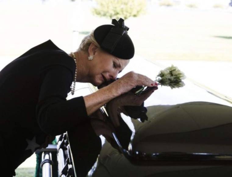 In this photo released by the McCain Family, Cindy McCain lays her head on the casket of her husband Senator John McCain (R-AZ) during a burial service at the cemetery at the United States Naval Academy on September 2, 2018, in Annapolis, Maryland. <br/>A nearly weeklong celebration of the life of US senator John McCain -- war hero, maverick, two-time presidential candidate and outspoken critic of Donald Trump -- came to a solemn and subdued end on as he was laid to rest at the US Naval Academy in Annapolis, Maryland. / AFP PHOTO / McCain Family / David Hume Kennerly / RESTRICTED TO EDITORIAL USE - MANDATORY CREDIT 'AFP PHOTO / McCain Family/ David Hume Kennerly- NO MARKETING NO ADVERTISING CAMPAIGNS - DISTRIBUTED AS A SERVICE TO CLIENTS<br/><br/>