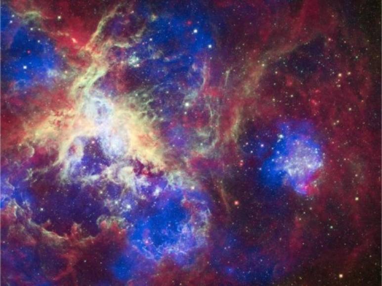 Nebulosa de la Tarántula.<br/><br/>Esta imagen de la nebulosa de la Tarántula, 30 Doradus o NGC 207, contiene datos del Observatorio Chandra de Rayos X (en color azul), del Hubble (en color verde), y del Spitzer (en color rojo). Situada en la Gran Nube de Magallanes, la Nebulosa de la Tarántula es una de las regiones más grandes que forman las estrellas cerca de la Vía Láctea. Y también de las más luminosas.