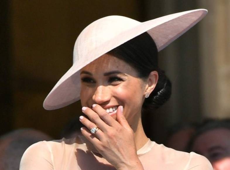 Britain's Meghan, Duchess of Sussex, laughs as she attends the Prince of Wales's 70th Birthday Garden Party at Buckingham Palace in London on May 22, 2018.<br/>The Prince of Wales and The Duchess of Cornwall hosted a Garden Party to celebrate the work of The Prince's Charities in the year of Prince Charles's 70th Birthday. / AFP PHOTO / POOL / Dominic Lipinski