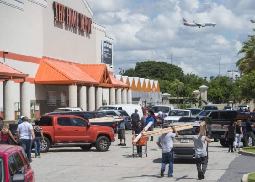 La gente sale se preparan para el huracán Irma con suministros fuera de una tienda de Home Depot en Miami, Florida. AFP