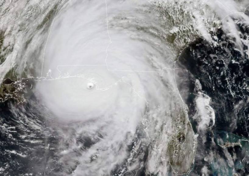 This NOAA/RAMMB satellite image taken on October 10, 2018 at 16:45 UTC shows Hurricane Michael as it approaches land near the US Gulf Coast. - Hurricane Michael was on a collision course with the southern US state of Florida on October 10, 2018 as weather forecasters warned that the Category 4 storm of historic intensity could be 'incredibly catastrophic.'Powerful winds, devastating storm surge and heavy rain were predicted for when Michael makes landfall later in the day in the Florida Panhandle, the finger-shaped strip of land along the Gulf of Mexico. (Photo by Lizabeth MENZIES / NOAA/RAMMB / AFP) / RESTRICTED TO EDITORIAL USE - MANDATORY CREDIT 'AFP PHOTO / NOAA/RAMMB' - NO MARKETING NO ADVERTISING CAMPAIGNS - DISTRIBUTED AS A SERVICE TO CLIENTS