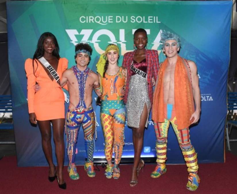 ATLANTA, GEORGIA - DECEMBER 04: Miss Sierra Leone Marie Esther Bangura and Miss Tanzania Shubila Stanton pose with cast members of Volta during Volta By Cirque Du Soleil at Atlantic Station on December 04, 2019 in Atlanta, Georgia. Paras Griffin/Getty Images for Cirque du Soleil/AFP