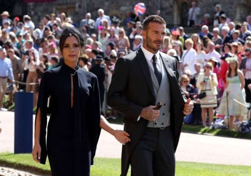Former England footballer David Beckham (R) and fashion designer Victoria Beckham (L) arrive for the wedding ceremony of Britain's Prince Harry, Duke of Sussex and US actress Meghan Markle at St George's Chapel, Windsor Castle, in Windsor, on May 19, 2018. / AFP PHOTO / POOL / Chris Radburn