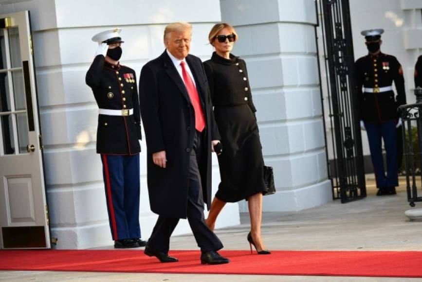 US President Donald Trump and First Lady Melania make their way to board Marine One before departing from the South Lawn of the White House in Washington, DC on January 20, 2021. - President Trump travels his Mar-a-Lago golf club residence in Palm Beach, Florida, and will not attend the inauguration for President-elect Joe Biden. (Photo by MANDEL NGAN / AFP)