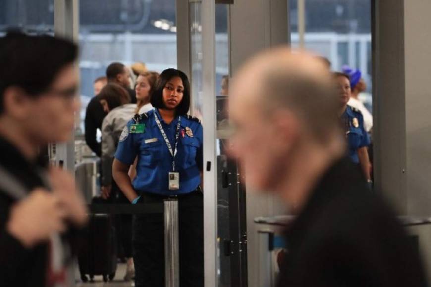 CHICAGO, ILLINOIS - JANUARY 07: A Transportation Security Administration (TSA) worker screens passengers and airport employees at O'Hare International Airport on January 07, 2019 in Chicago, Illinois. TSA employees are currently working under the threat of not receiving their next paychecks, scheduled for January 11, because of the partial government shutdown now in its third week. As a result, there have been reports of an increase in TSA workers calling in sick at some airports. Scott Olson/Getty Images/AFP