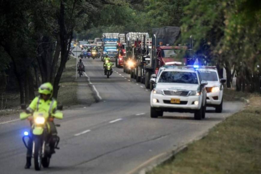 Trucks loaded with humanitarian aid for Venezuela arrive at the Tienditas Bridge in Cucuta, Colombia, on the border with Tachira, Venezuela, on February 16, 2019. - Venezuelan opposition leader Juan Guaido on Saturday called for nationwide protests next week to support volunteers planning to travel to the border with Colombia to bring in US humanitarian aid, the latest flashpoint in the country's political crisis. The announcement came as tons of US food aid was piling up along the border. It has been denounced by President Nicolas Maduro, who has asked the military to reinforce the frontier, denouncing the food as a 'booby trap' and a cover, he said, for a planned US military invasion. (Photo by Luis ROBAYO / AFP)