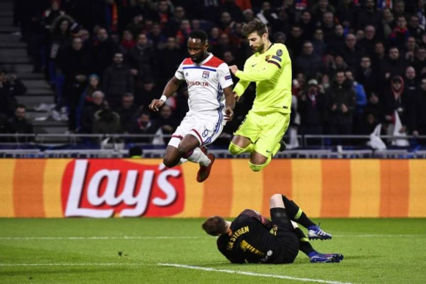 Moussa Dembélé y Gerard Piqué saltan mientras Ter Stegen se queda con el balón.