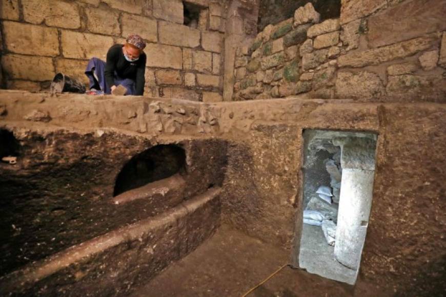 Tehila Sadiel, an archaeologist of the Israel Antiquities Authority, worsk at an excavation at a subterranean system hewn in the bedrock beneath a 1400-year-old building near the Western Wall in Jerusalem's Old City, on May 19, 2020. (Photo by MENAHEM KAHANA / AFP)