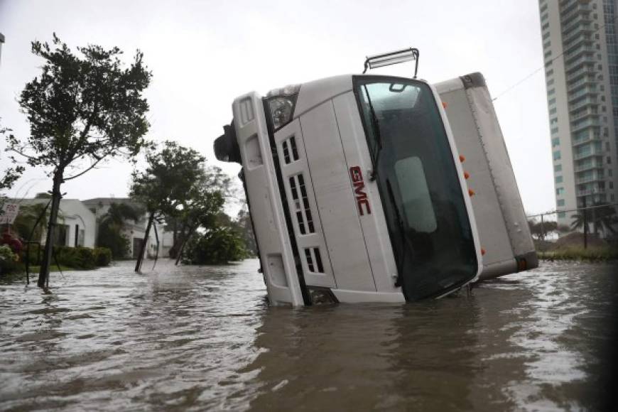 MIAMI, FL - SEPTEMBER 10: A truck is seen on its side after being blown over as Hurricane Irma passed through on September 10, 2017 in Miami, Florida. Hurricane Irma, which first made landfall in the Florida Keys as a Category 4 storm on Sunday, has weakened to a Category 2 as it moves up the coast. Joe Raedle/Getty Images/AFP<br/><br/>== FOR NEWSPAPERS, INTERNET, TELCOS & TELEVISION USE ONLY ==<br/><br/>