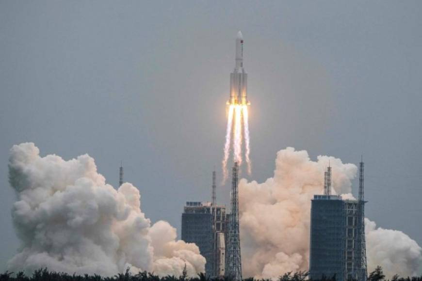 (FILES) This file photo taken on April 29, 2021 shows a Long March 5B rocket, carrying China's Tianhe space station core module, lifting off from the Wenchang Space Launch Center in southern China's Hainan province. - A large segment of the Long March 5B rocket re-entered the Earth's atmosphere and disintegrated over the Indian Ocean, state television reported on May 9, 2021 citing the China Manned Space Engineering Office, following fevered speculation over where the 18-tonne object would come down. (Photo by STR / AFP) / China OUT