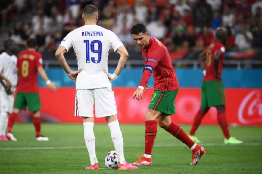 Cristiano Ronaldo hace un gesto hacia el balón mientras el delantero francés Karim Benzema se prepara para el penal.