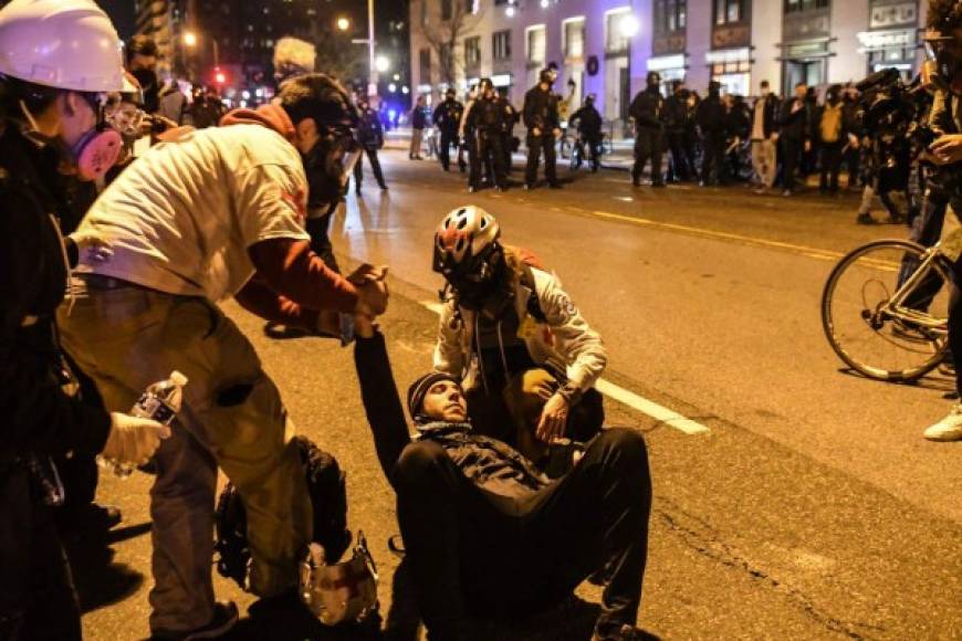 WASHINGTON, DC - DECEMBER 12: A counter protester is attended to by medics during a protest on December 12, 2020 in Washington, DC. Thousands of protesters who refuse to accept that President-elect Joe Biden won the election are rallying ahead of the electoral college vote to make Trump's 306-to-232 loss official. Stephanie Keith/Getty Images/AFP<br/><br/>== FOR NEWSPAPERS, INTERNET, TELCOS & TELEVISION USE ONLY ==<br/><br/>