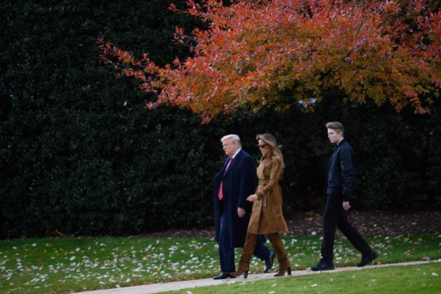 US President Donald Trump, First Lady Melania Trump and their son Barron depart the White House in Washington, DC, on November 26, 2019. (Photo by JIM WATSON / AFP)