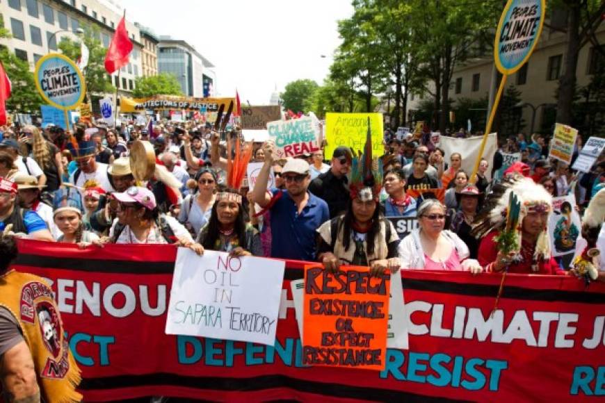 US actor Leonardo DiCaprio (C) marches with a group of indigenous people from North and South America, during the People's Climate March in Washington DC, on April, 29, 2017. / AFP PHOTO / Jose Luis Magana