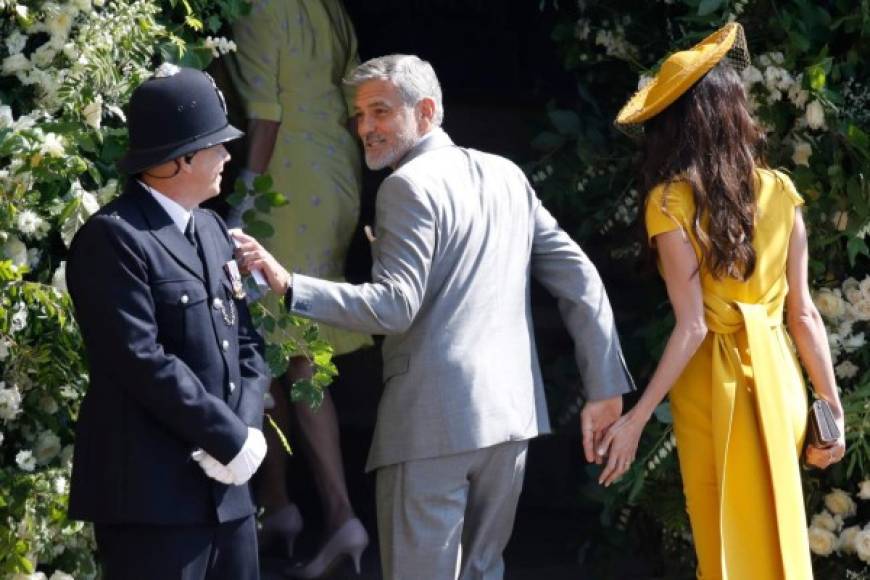 El actor George Clooney saluda a un policía.