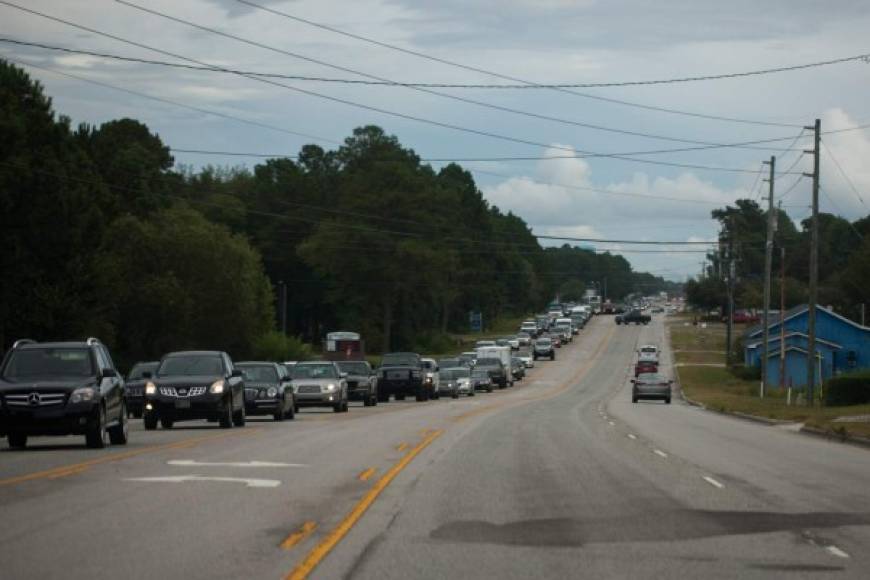 Vehicles line up along State Route 17 as people evacuate the coast of North Carolina on September 11, 2018 in Hampstead, North Carolina before the arrival of Hurricane Florence. <br/>More than a million people were under evacuation orders in the eastern United States Tuesday, where powerful Hurricane Florence threatened catastrophic damage to a region popular with vacationers and home to crucial government institutions. / AFP PHOTO / Logan Cyrus