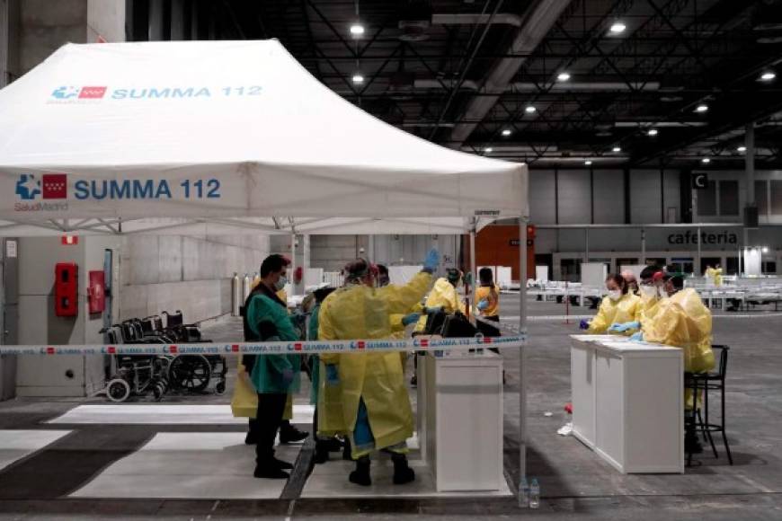 This handout picture made available by Madrid´s regional government, Comunidad de Madrid, shows patients arriving at the temporary hospital set up for coronavirus patients at a pavilion in Ifema convention and exhibition center in Madrid, on March 21, 2020. - Spain announced 394 new deaths caused by the novel coronavirus, raising to 1,720 the official death toll in Europe's worst-hit country after Italy, a 30 percent increase over the previous day. (Photo by - / COMUNIDAD DE MADRID / AFP) / RESTRICTED TO EDITORIAL USE - MANDATORY CREDIT 'AFP PHOTO / HANDOUT / COMUNIDAD DE MADRID - NO MARKETING - NO ADVERTISING CAMPAIGNS - DISTRIBUTED AS A SERVICE TO CLIENTS