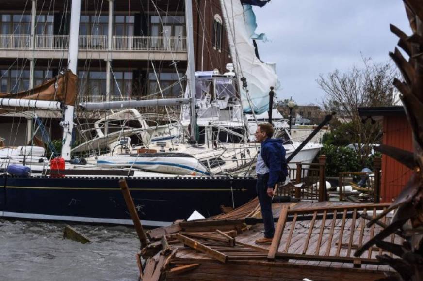 A man stands on the broken dock to check his boat during Hurricane Sally in downtown Pensacola, Florida on September 16, 2020. - Hurricane Sally barrelled into the US Gulf Coast early Wednesday, with forecasts of drenching rains that could provoke 'historic' and potentially deadly flash floods.The National Hurricane Center (NHC) said the Category 2 storm hit Gulf Shores, Alabama at about 4:45 am (0945 GMT), bringing maximum sustained winds of about 105 miles (165 kilometers) per hour.'Historic life-threatening flooding likely along portions of the northern Gulf coast,' the Miami-based center had warned late Tuesday, adding the hurricane could dump up to 20 inches (50 centimeters) of rain in some areas. (Photo by CHANDAN KHANNA / AFP)