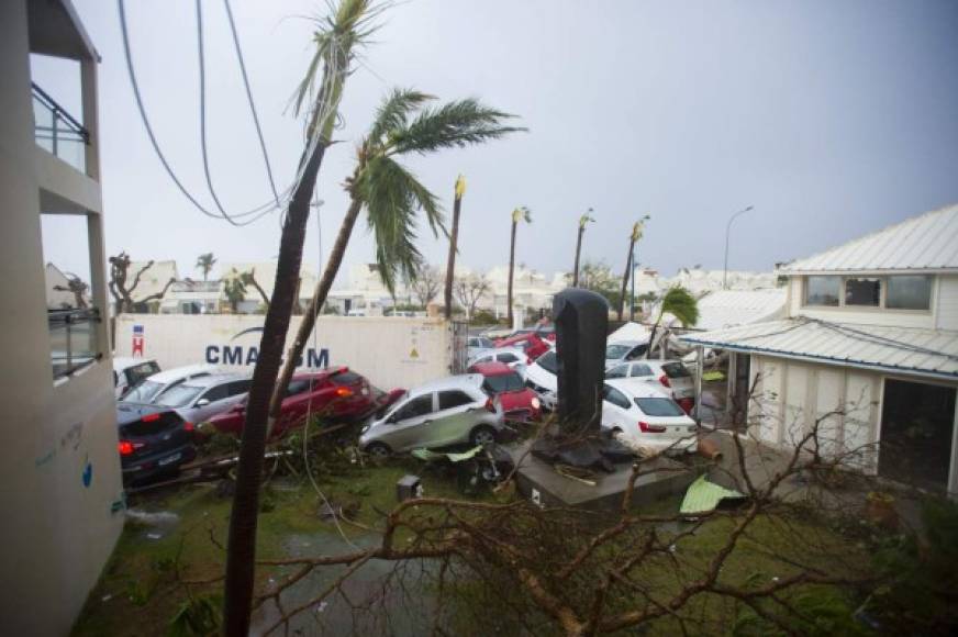 A photo taken on September 6, 2017 shows cars piled on top of one another at the Hotel Mercure in Marigot, near the Bay of Nettle, on the French Collectivity of Saint Martin, after the passage of Hurricane Irma.<br/>France, the Netherlands and Britain on September 7 sent water, emergency rations and rescue teams to their stricken territories in the Caribbean hit by Hurricane Irma, which has killed at least 10 people. The worst-affected island so far is Saint Martin, which is divided between the Netherlands and France, where eight of the 10 confirmed deaths took place.<br/> / AFP PHOTO / Lionel CHAMOISEAU