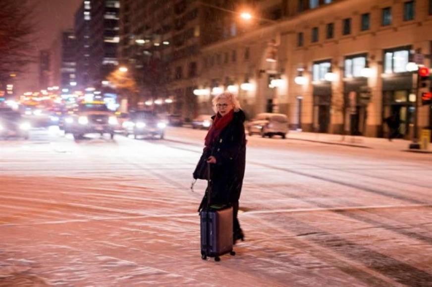 Una mujer camina por las nevadas calles de la ciudad de Washington.