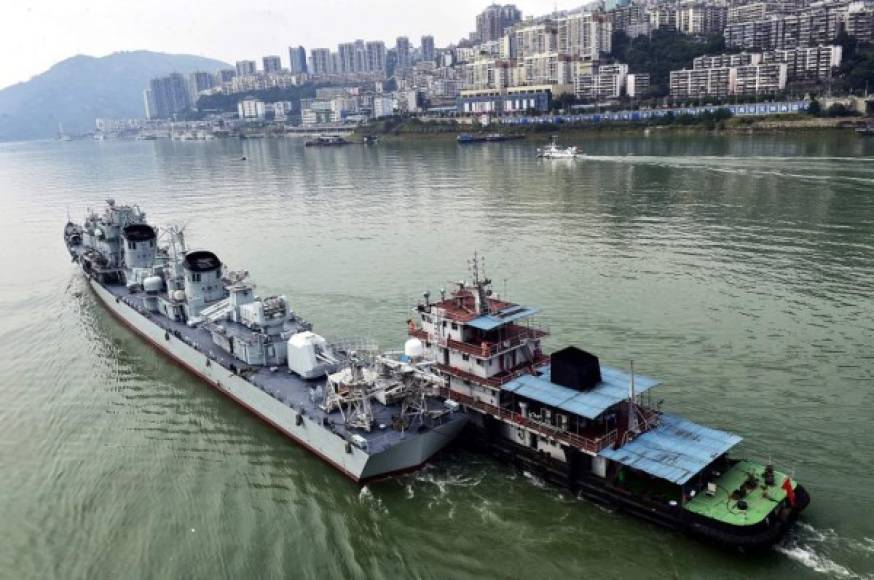 This photo taken on October 18, 2020 shows the Zhuhai (L), the last of Chinas Type 051 guided-missile destroyers, passing through Fengjie county, Chongqing province in the Three Gorges on the Yangtze River. - The Zhuhai, which was commisioned to the Navys South China Sea fleet in 1992 and retired in August 2020, became the first warship to pass through the famed Three Gorges, on its way to Chongqing where it will be converted into a floating national defense education-themed museum. (Photo by STR / AFP) / China OUT