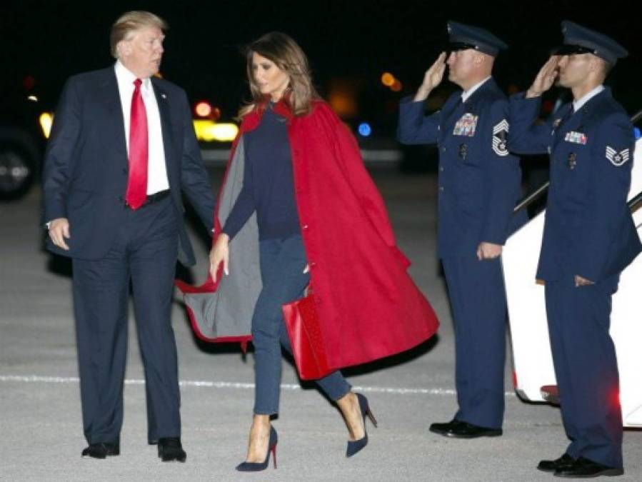 Melania, que lucía un jersey azul marino, jeans, y un dramático abrigo rojo a modo de capa de Maison Ullens con sus zapatos de tacón Christian Louboutin, ignoró el protocolo de posar junto a su esposo, dejándolo solo frente a los periodistas.