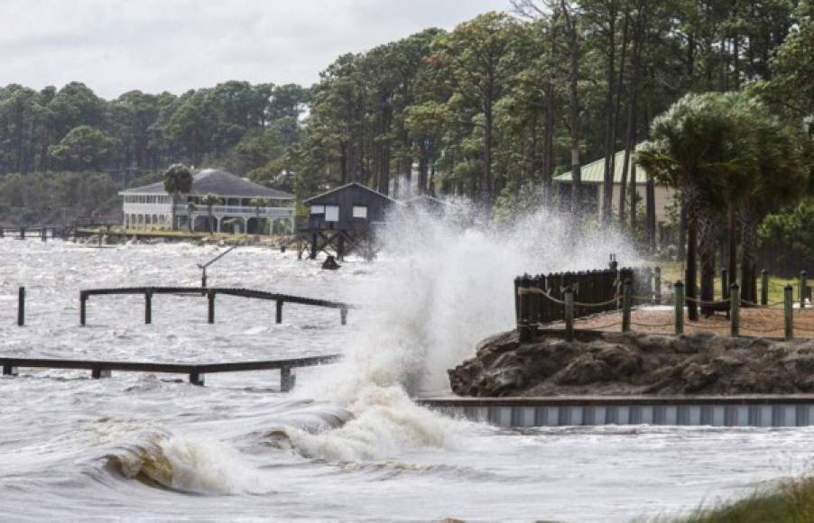 EASTPOINT, FL - OCTOBER 09: Waves crash against a home seawall as the surge starts pushing the tide higher as Hurricane Michael approaches on October 9, 2018 in Eastpoint, Florida. The hurricane is forecast to hit the Florida Panhandle at a possible category 3 storm. Mark Wallheiser/Getty Images/AFP