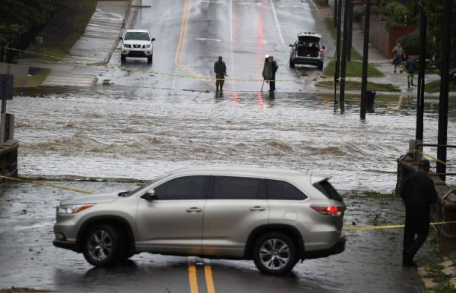 Richardson Tumulak brings a candle into and elderly couples room after the Sleep Inn hotel they were staying in lost power on September 13, 2018 during Hurricane Florence. <br/>Florence smashed into the US East Coast Friday with howling winds, torrential rains and life-threatening storm surges as emergency crews scrambled to rescue hundreds of people stranded in their homes by flood waters. Forecasters warned of catastrophic flooding and other mayhem from the monster storm, which is only Category 1 but physically sprawling and dangerous. / AFP PHOTO / Logan Cyrus