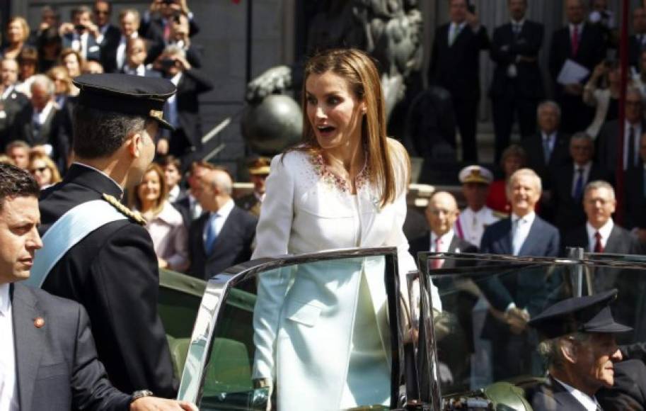 Felipe ayuda a la reina Letizia a subir a un Rolls Royce Phantom IV 4AF18 para recorrer las calles de Madrid hasta el palacio Real en los actos de proclamación del rey Felipe VI. <br/><br/>Para tan importante día, los nuevos Reyes utilizaron el mismo coche en el que recorrieron las calles de Madrid el día de su boda.<br/><br/>