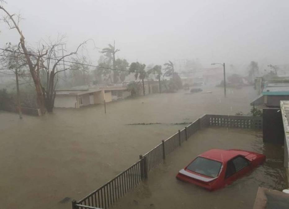 A police car patrols a dark street in the aftermath of Hurricane Maria in San Juan, Puerto Rico, on September 21, 2017.<br/>Puerto Rico battled dangerous floods Friday after Hurricane Maria ravaged the island, as rescuers raced against time to reach residents trapped in their homes and the death toll climbed to 33. Puerto Rico Governor Ricardo Rossello called Maria the most devastating storm in a century after it destroyed the US territory's electricity and telecommunications infrastructure.<br/> / AFP PHOTO / Ricardo ARDUENGO (Photo credit should read RICARDO ARDUENGO/AFP/Getty Images)