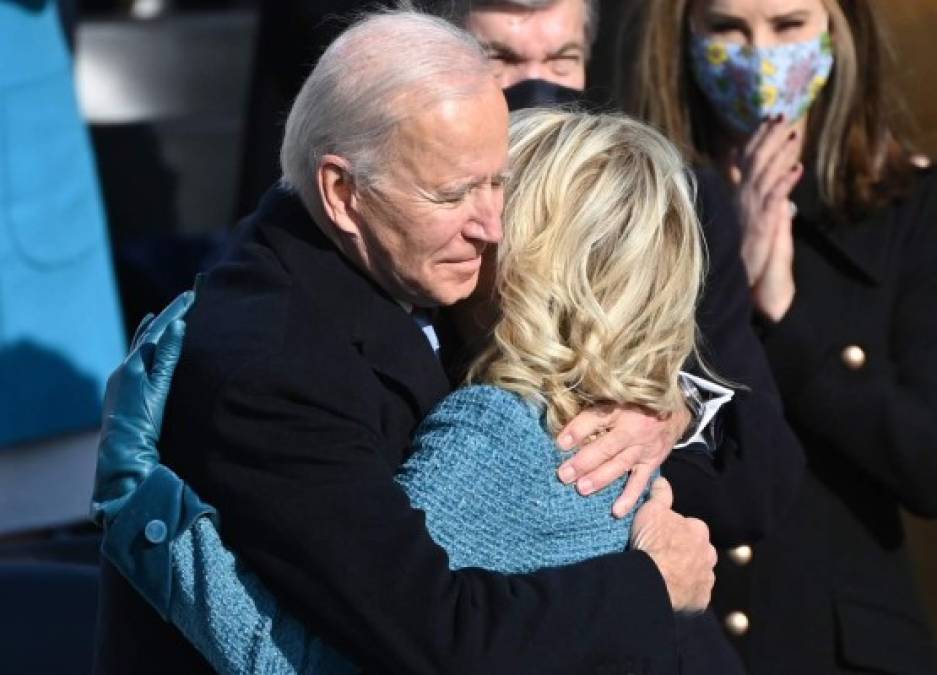 Joe Biden embraces his wife Jill after being sworn in as the 46th US President by Supreme Court Chief Justice John Roberts on January 20, 2021, at the US Capitol in Washington, DC. (Photo by Brendan SMIALOWSKI / AFP)